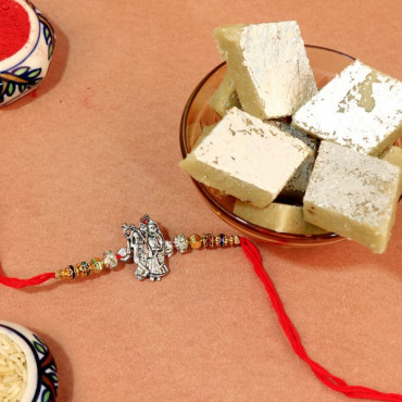 Delectable Kajukatli with Radhe Krishna Rakhi