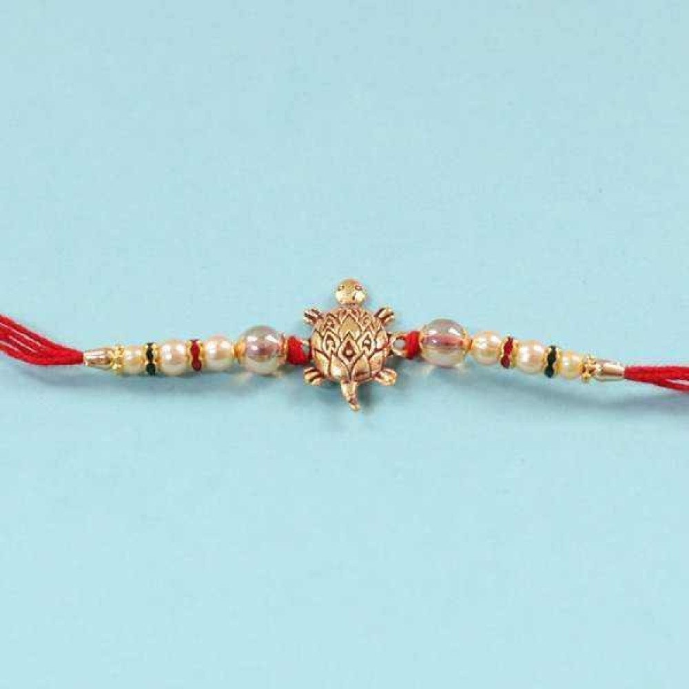 Tortoise Rakhi Tied With Pearl Threads