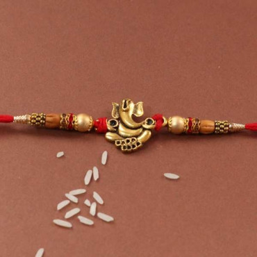 Lord Ganesha Metal Rakhi Tied With Thread