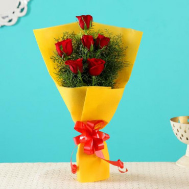 Red Roses In Yellow Paper