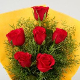 Red Roses In Yellow Paper
