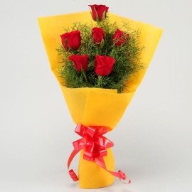 Red Roses In Yellow Paper